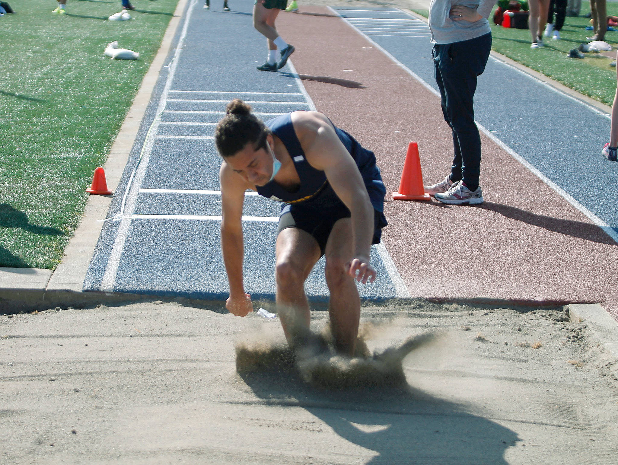 Isaac Agnew of Bainbridge makes his leap in the long jump. He finished seventh with a jump of 18 feet, 4.5 inches. (Mark Krulish/Kitsap News Group)