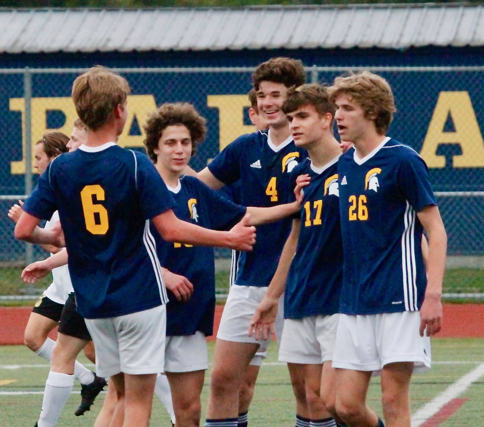 Bainbridge gathers to celebrate Ben Wilkinson’s 30th-minute goal that ultimately helped the team clinch the Olympic League championship. (Mark Krulish/Kitsap News Group)