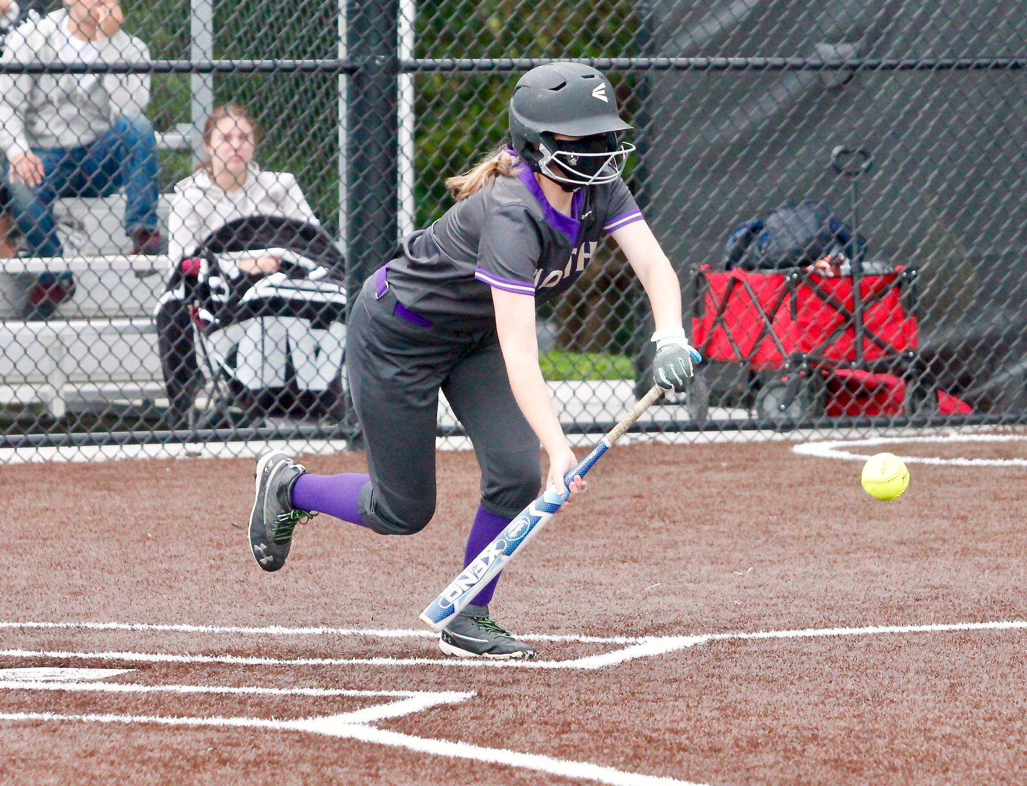 Samantha Burgh drops down a bunt against Sequim. Burgh recorded two hits and a sacrifice in the 2-1 victory. (Mark Krulish/Kitsap News Group)