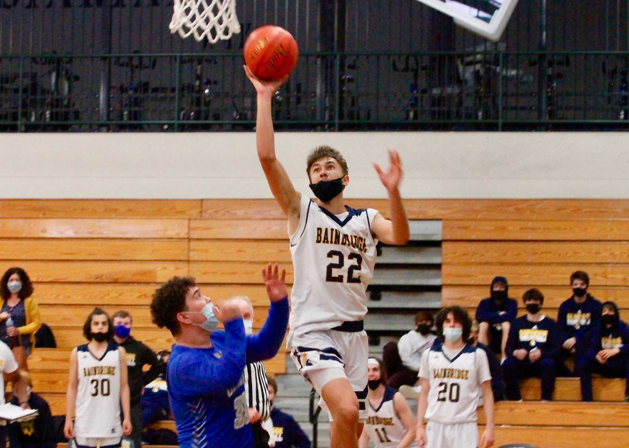 Everett Moore gets up and over the Olympic defense for a shot attempt. Moore hit four 3-pointers in Bainbridge’s win over the Trojans. (Mark Krulish/Kitsap News Group)