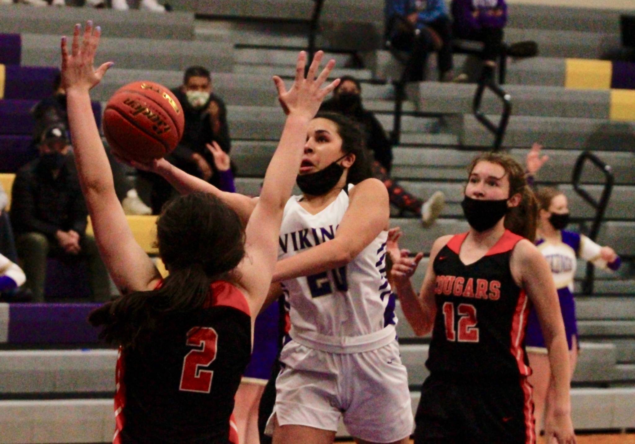 Mia McNair tries to get around Central Kitsap’s Hailey Carrol on her way to the basket. (Mark Krulish/Kitsap News Group)