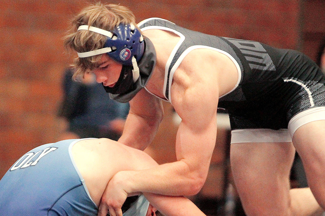 Xavier Eaglin was one of seven seniors honored on Senior Night. He wrestled at 160 pounds and defeated his opponent from Olympia via pin early in the second period. (Mark Krulish/Kitsap News Group)