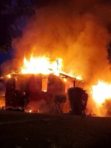 The two-story Kingston home was fully engulfed in flames when firefighters arrived. Courtesy Photos