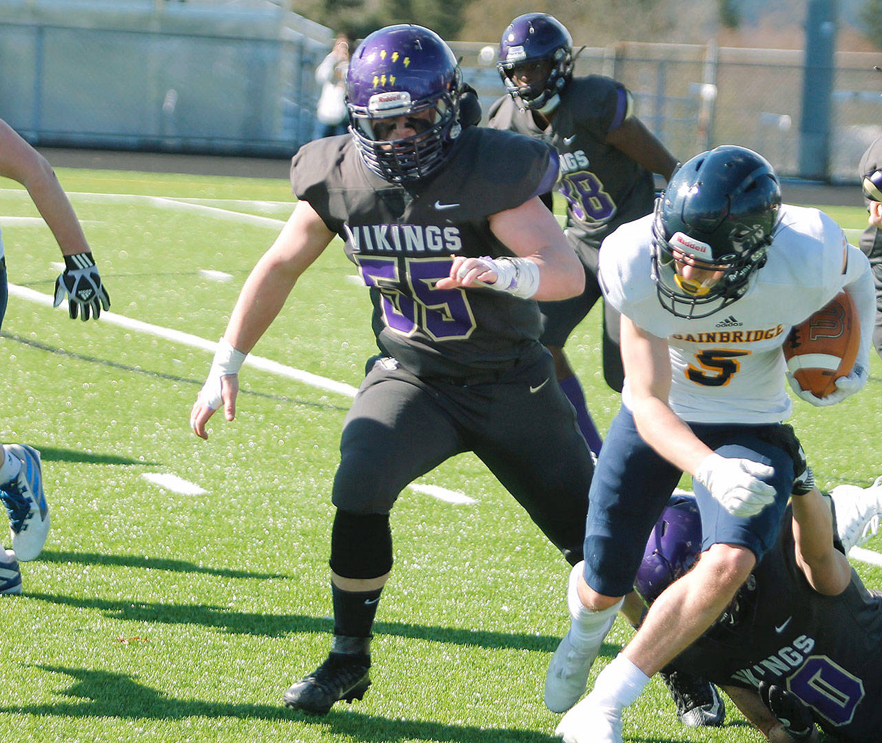 Cache Holmes, shown here chasing down Bainbridge’s Cal Breen, will play football and wrestle at Southern Virginia in the fall. (KNG File Photo)