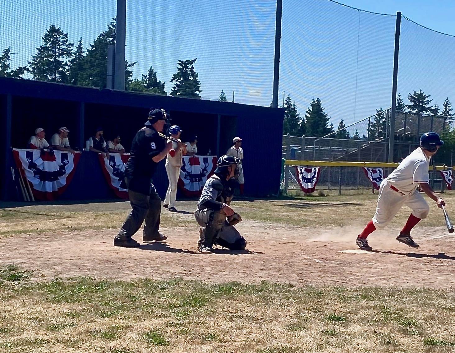 Ben Kussie digs out of the box for the Reds in the 18th annual old-timers and alumni Stars and Strikes game as MacKenzie Bond waits on deck. Bond tripled home Kussie in the bottom of the seventh to tie the game and send it to extra innings. (Photo courtesy Paimon Jaberi)