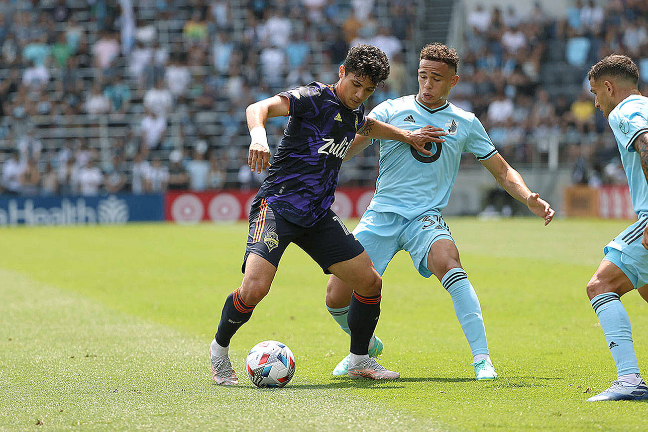 Fredy Montero holds off a Minnesota United defender in the Sounders first loss of the season on Sunday. (Photo: Minnesota United FC)
