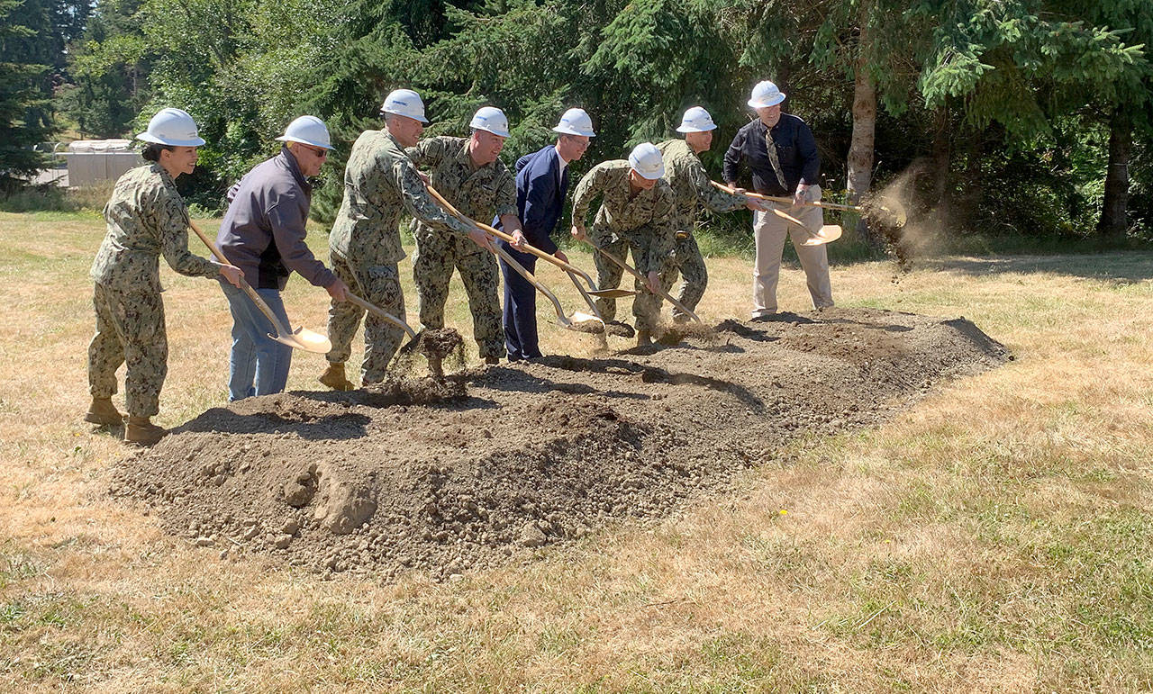 Navy officials and U.S. Rep. Derek Kilmer turn over shovels of dirt to signify the official start of the project to modernize the Manchester Fuel Depot’s fuel storage capability. (Bob Smith | Kitsap Daily News)