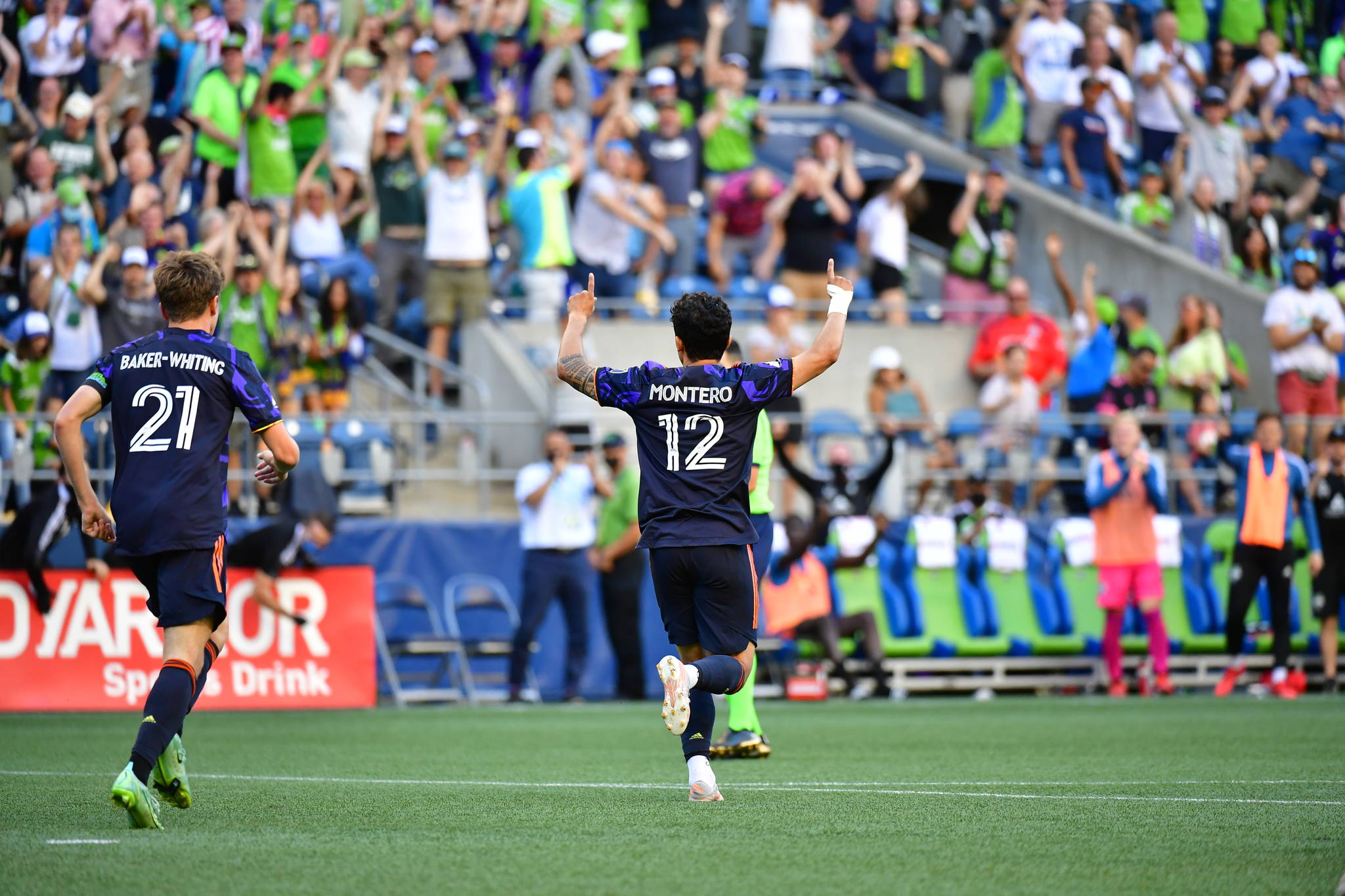 Freddy Montero raises his hands toward the large crowd of supporters after he scored his 50th regular season goal as a Sounder against Sporting KC. (Jane Gershovich/Sounders FC Communications)