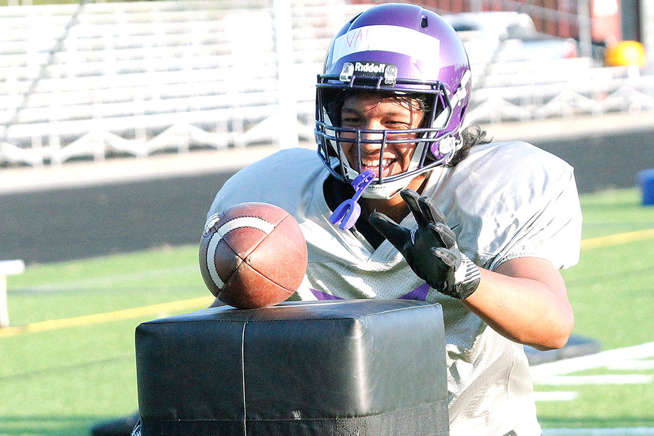 Happy to be back — North Kitsap sophomore EJ Vailolo goes for the ball in a drill during this week’s football practice. The Vikings’ first game is Sept. 3. (Mark Krulish/Kitsap News Group)