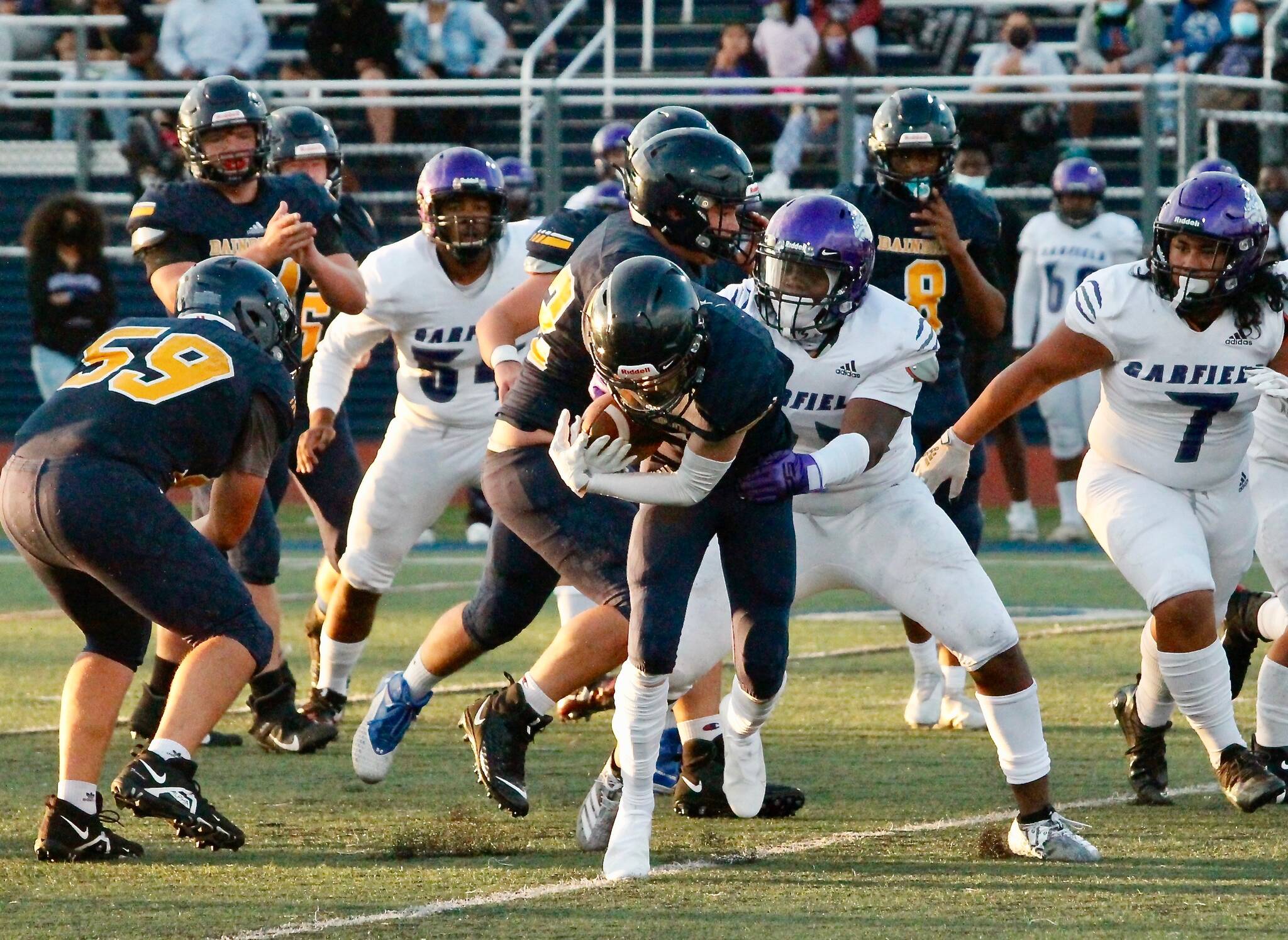 Bainbridge running back Matt LeDorze crashes through the line in the Spartans’ opening night game against Garfield. (Mark Krulish/Bainbridge Island Review)