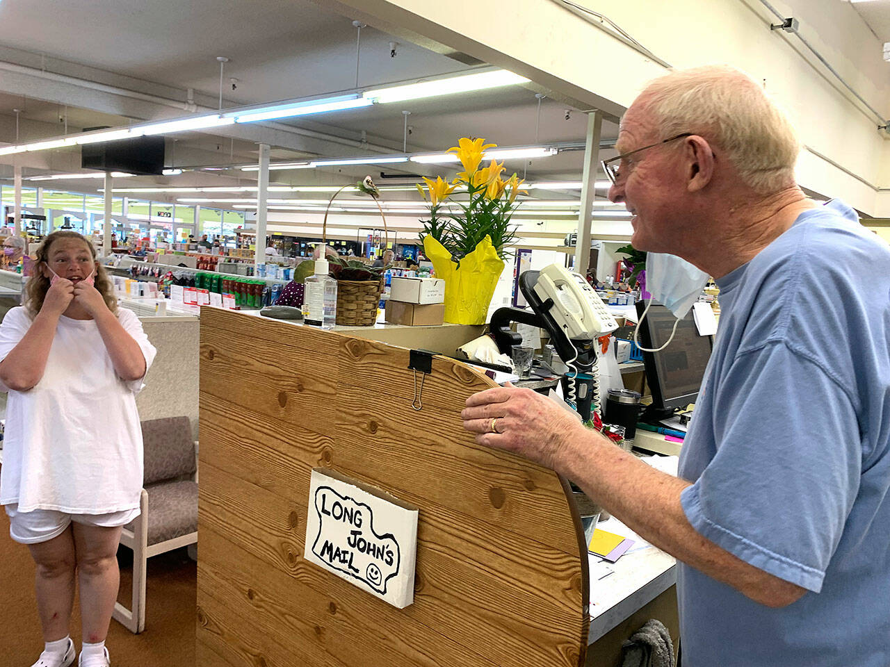 Customer Laura Reedy to retiring pharmacist Ken Paskett: “Ken, you can’t leave us!” she said with a smile. “What will we do without you?” (Bob Smith | Kitsap Daily News)