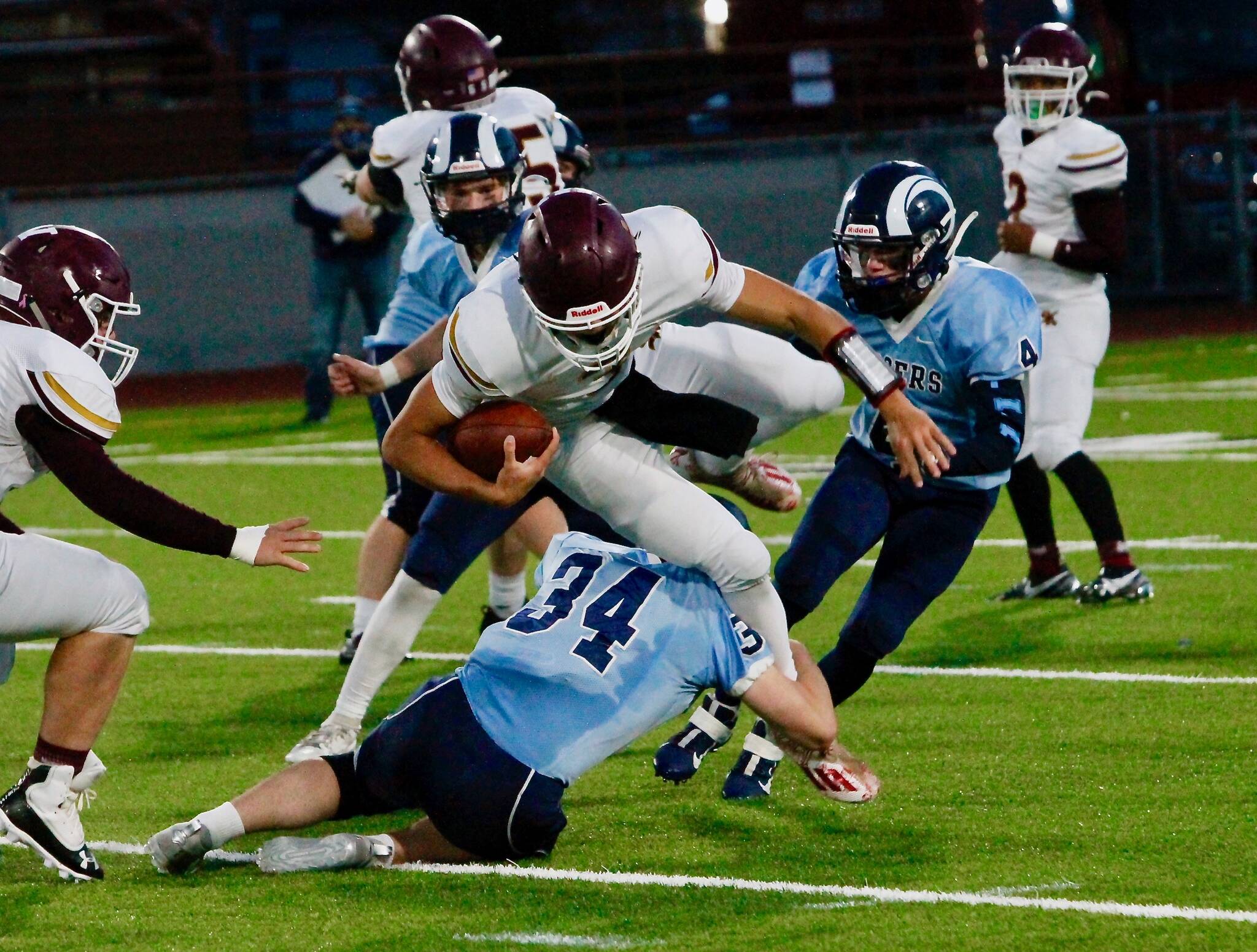 South Kitsap quarterback Mason Elena tries to go over a Rogers defender. (Mark Krulish/Kitsap News Group)