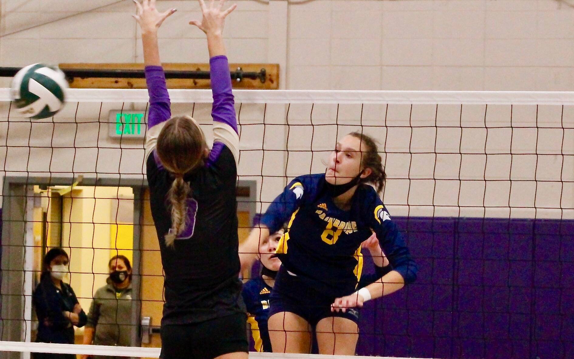 Allie Wildsmith of Bainbridge blasts a shot through the North Kitsap defense during her team’s five-set win on Thursday night. (Mark Krulish/Kitsap News Group)