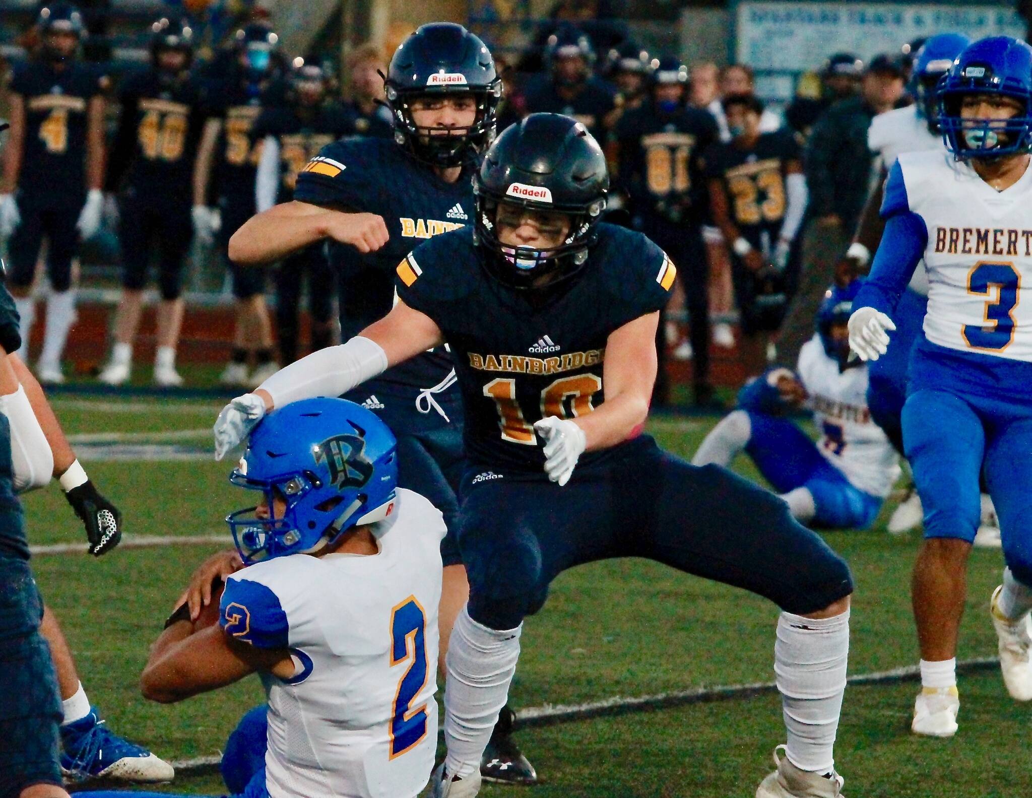 Bainbridge’s Caleb Durrance closes in on fallen Bremerton quarterback Joshua Tapangco during the Spartans 32-0 loss to the Knights. (Mark Krulish/Kitsap News Group)