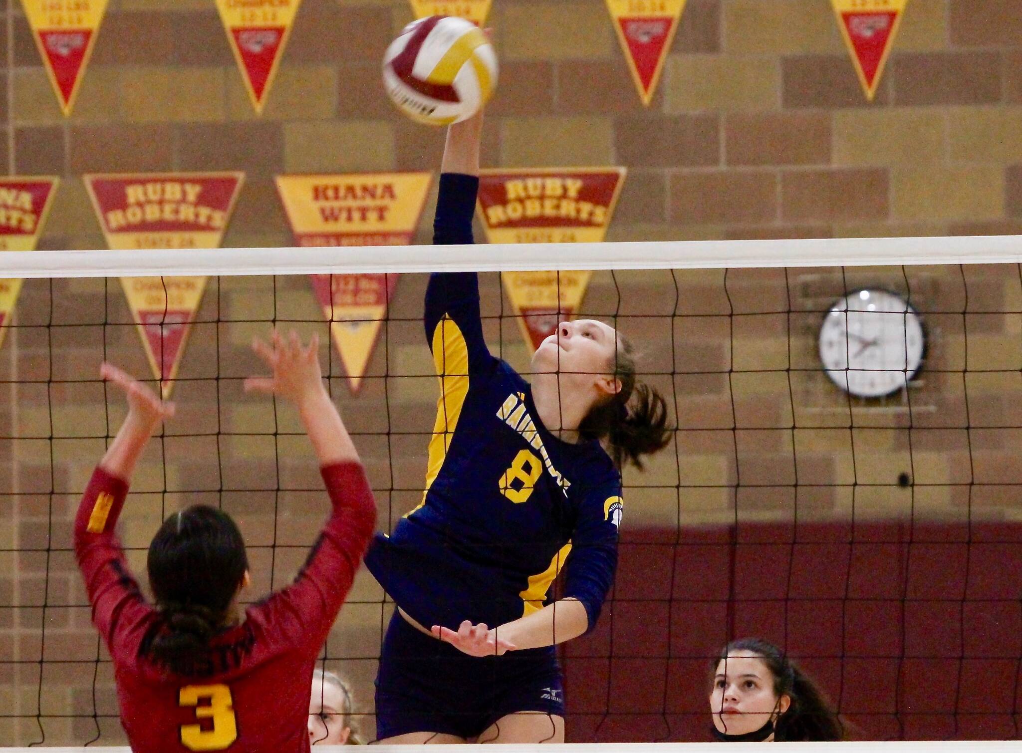 Bainbridge middle blocker Allie Wildsmith blasts a shot through Kingston’s defense in her team’s three-set win Tuesday night. (Mark Krulish/Kitsap News Group)