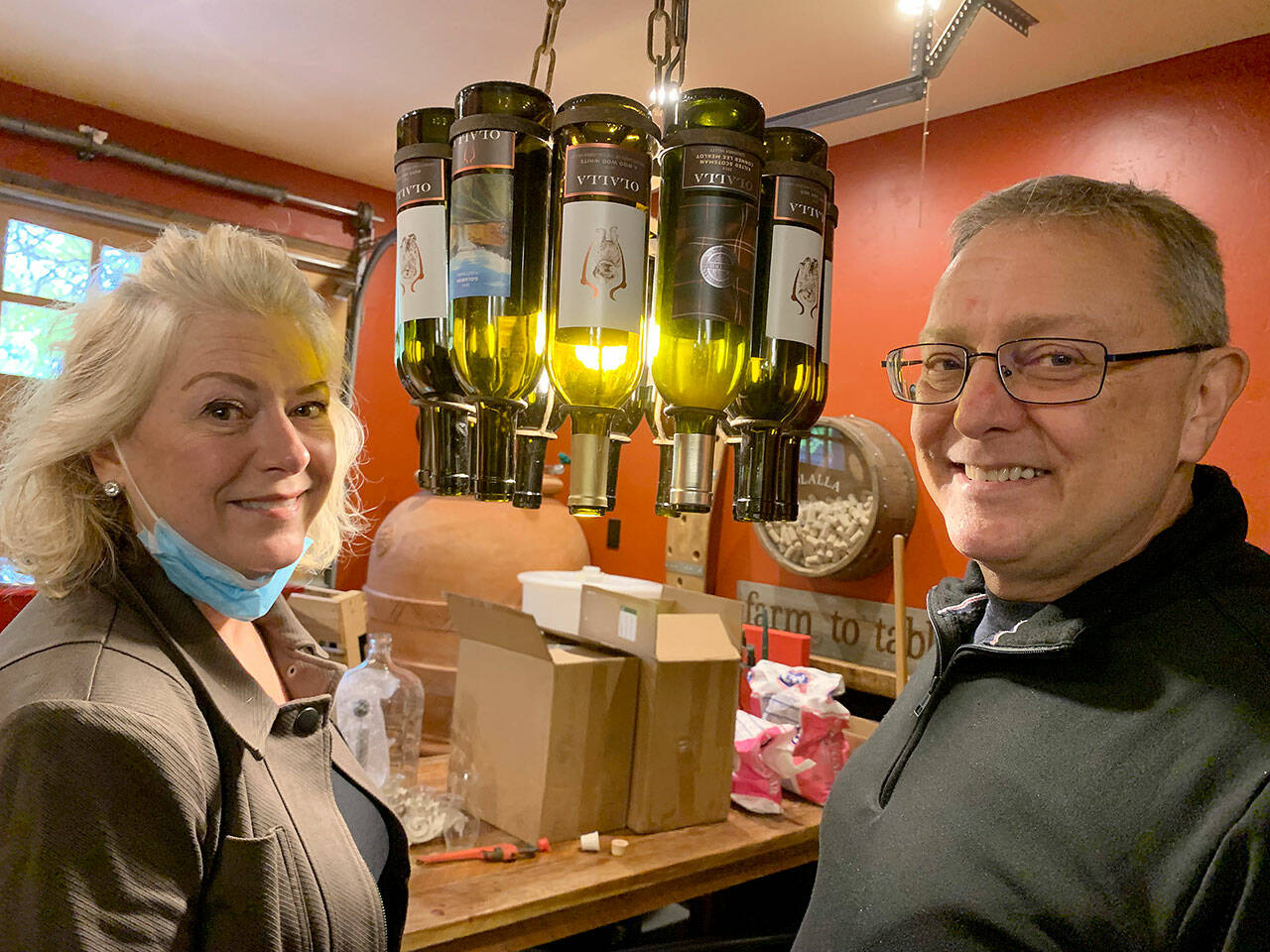 The couple has created wine labels that feature their canine pets, past and present (shown attached to wine bottles that make up a lamp). (Bob Smith | Kitsap Daily News)