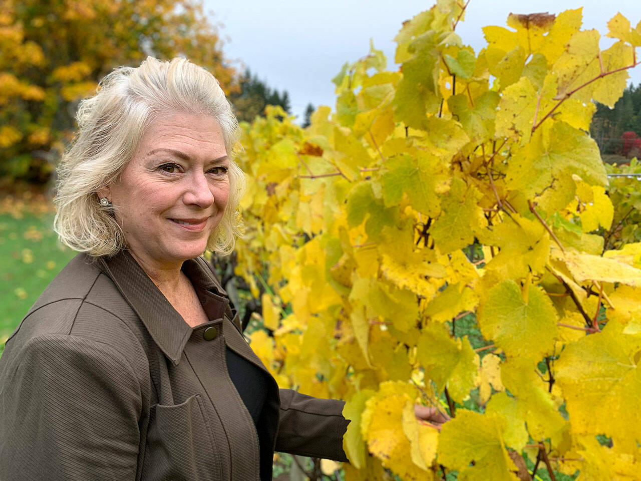 Mary Ellen Houston says she is an extrovert and loves interacting with people visiting the Olalla Vineyard and Winery’s tasting room. (Bob Smith | Kitsap Daily News)