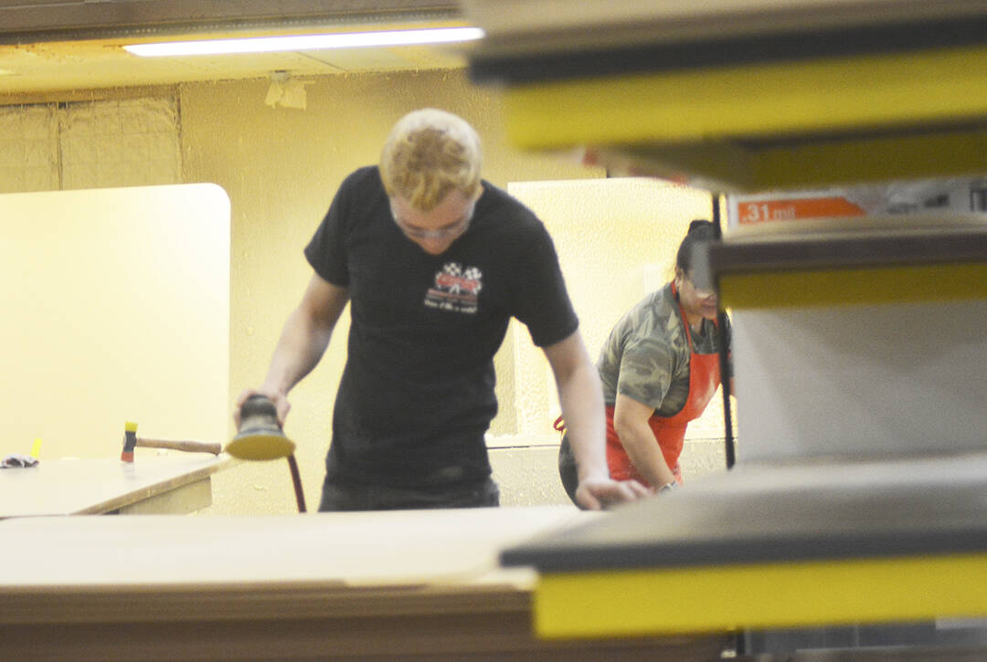 Workers prepare wood to be made into furniture. Steve Powell/North Kitsap Herald photos