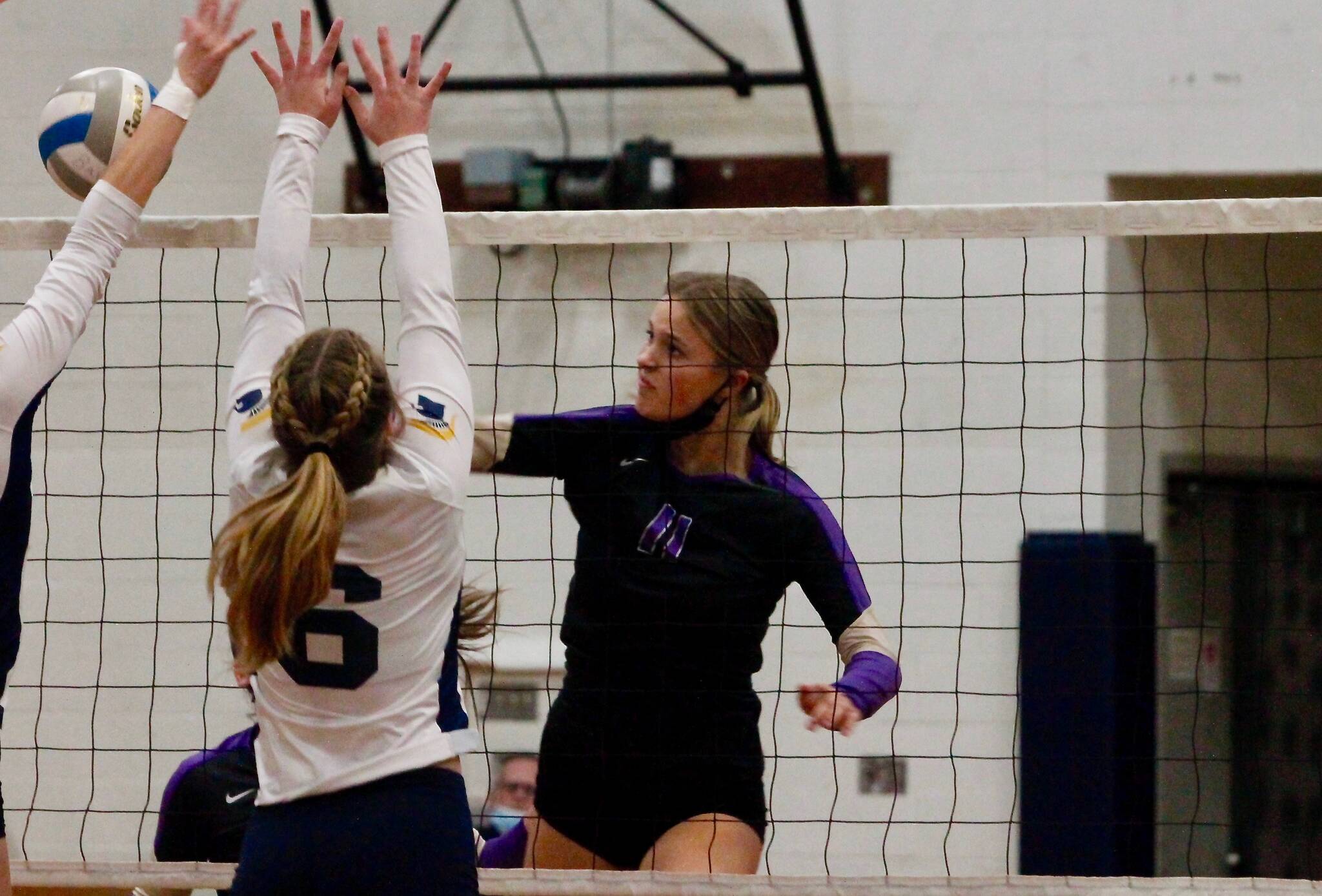 North Kitsap’s Maddie Pryde tips a shot past two Bainbridge defenders. The Vikings defeated the Spartans on Tuesday night to split their season series and share the top spot in the Olympic League. (Mark Krulish/Kitsap News Group)