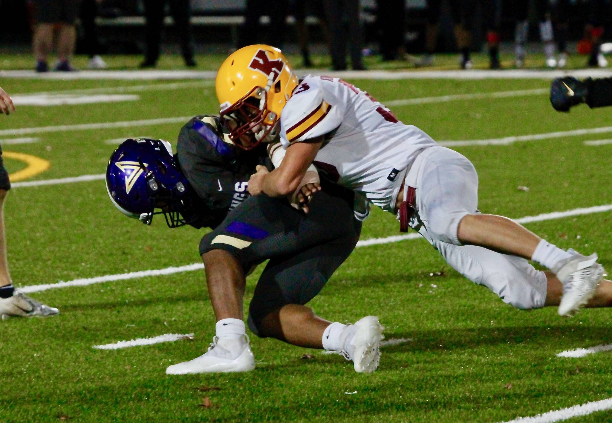 Kingston’s Camden Singer shoots through the line to make a tackle in the backfield against North Kitsap. (Mark Krulish/Kitsap News Group)