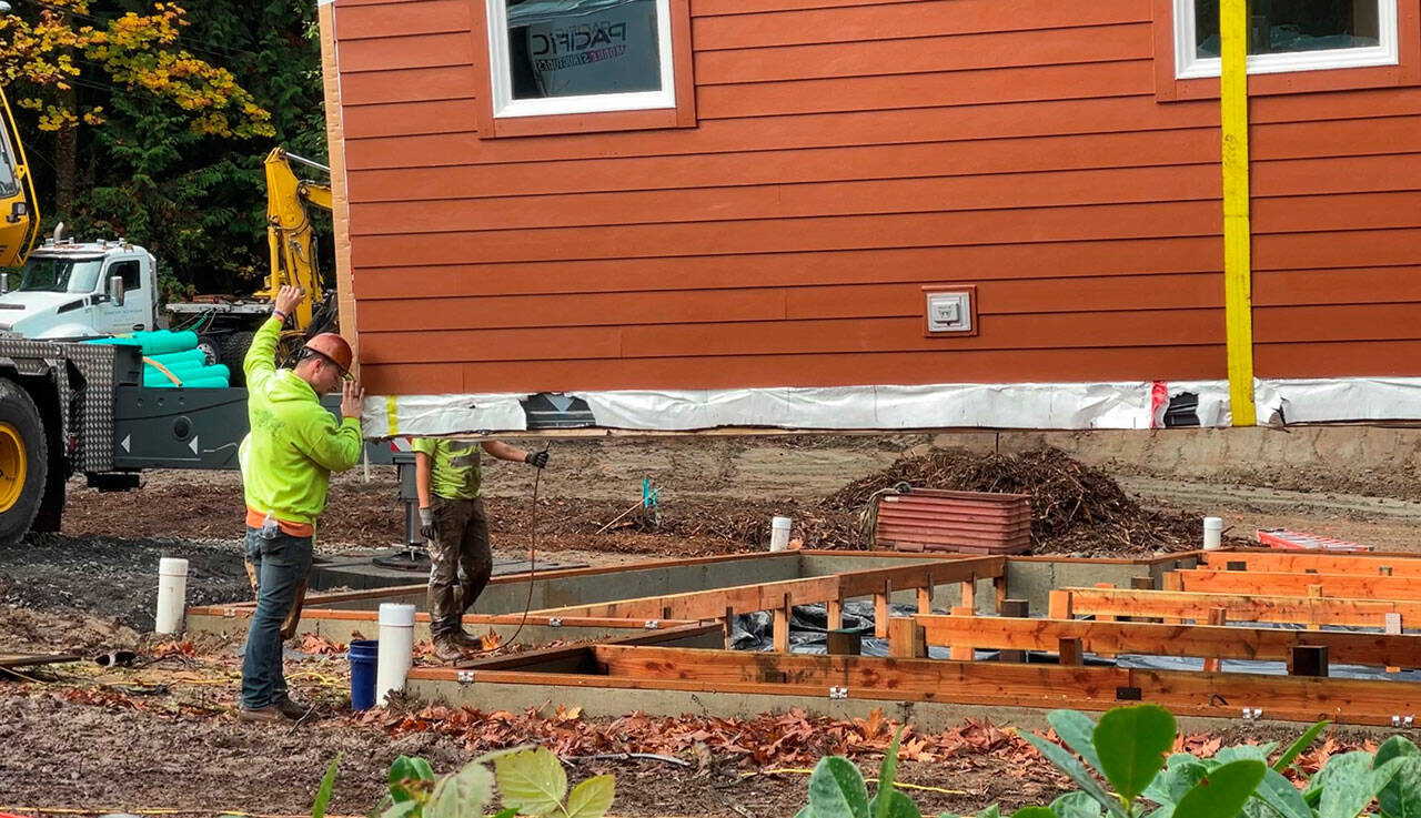 Construction workers set the first of six prefabricated modules that will create the Suquamish Tribe's Healing House health clinic. Courtesy photos