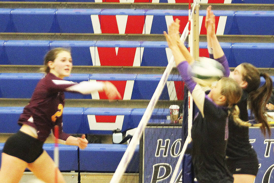 Two Viking blockers get smacked by a spike against White River.