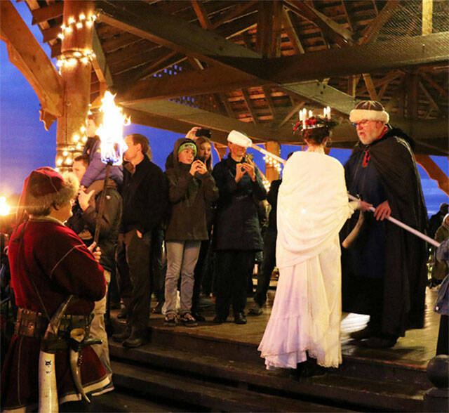 The Santa Lucia bride prepares to light the ceremonial bonfire at the 2019 Poulsbo Julefest. Herald file photos