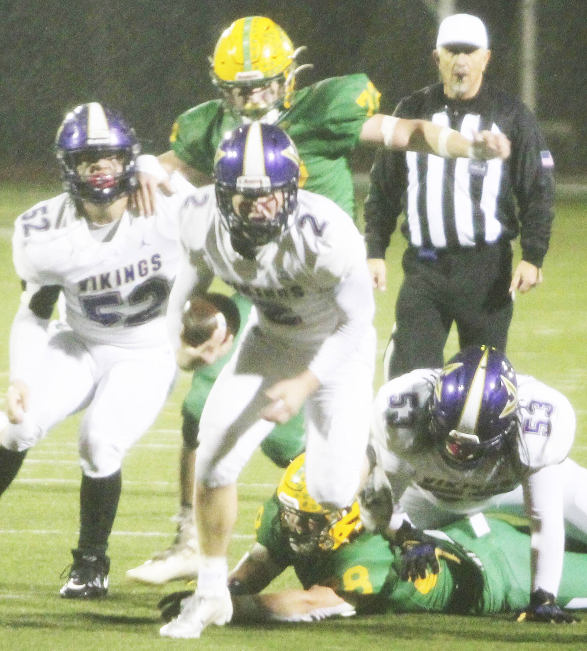 With the strong winds, Viking quarterback Colton Bower (2) was more effective running the ball in the first half. Here Quinn Knivila- Ruchie (52) and Jesus Mares (53) block for him. Steve Powell/North Kitsap Herald photographs
