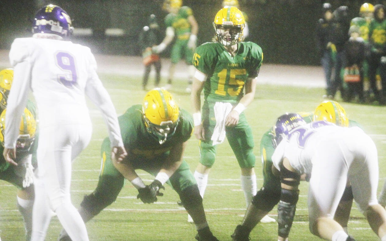 Jordan Reece keeps his eye on the Lynden quarterback just before Kaeden Hermanutz (15) got the snap in the shotgun and ran around the left end to score the Lions first touchdown.