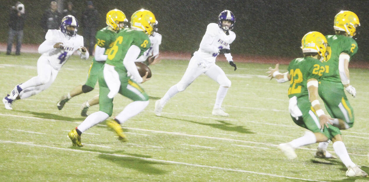Zeke Harris (4) and Morgan Paul (3) of North Kitsap try to chase down Lynden wide receiver Kaleo Jandoc in Saturday’s game.