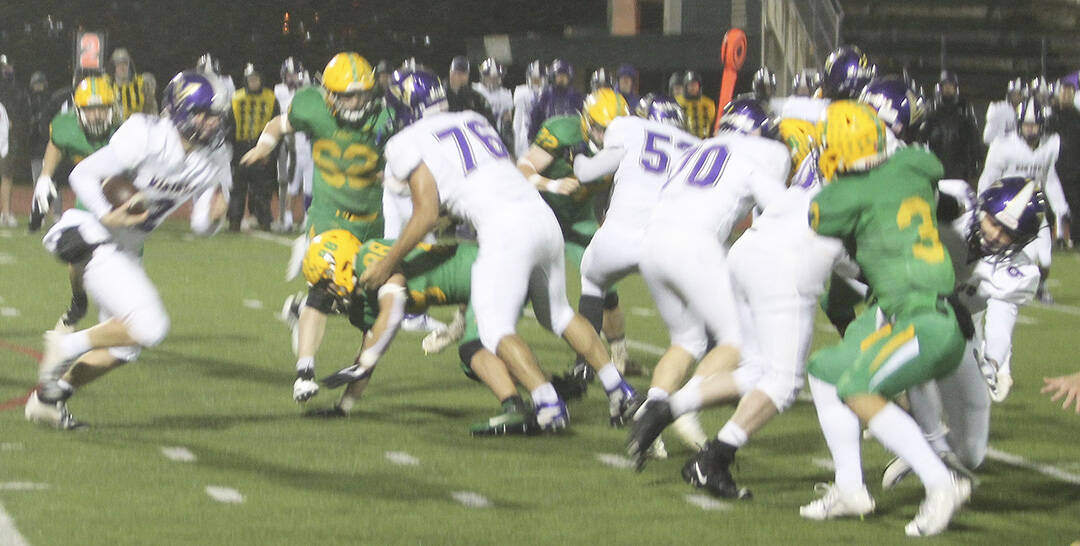 Sofian Hammou (76), Carter Dowlearn (70) and Jesus Mares (53) block for Colton Bower (2) as he takes off on a run.