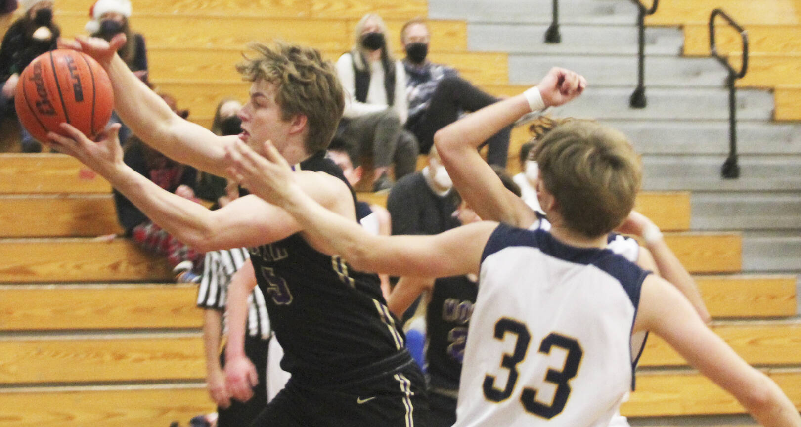 Colton Bower of North Kitsap and Caleb Durrance (33) of BI go after a rebound.