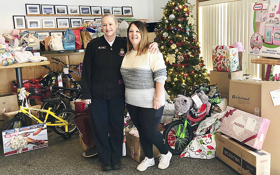 Courtesy photo
Salvation Army Capt. Dana Walters and Kim Clark, commodore of the Kingston Cove Yacht Club, are surrounded by a mountain of gifts destined for the Angel Tree program.
