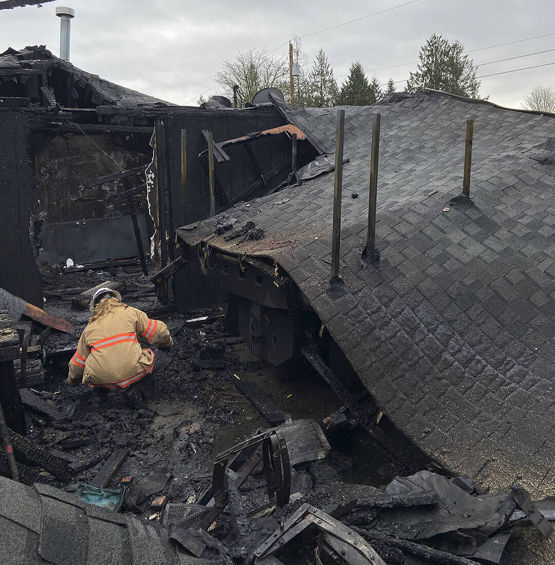 A firefighter checks through the damage. Courtesy photos