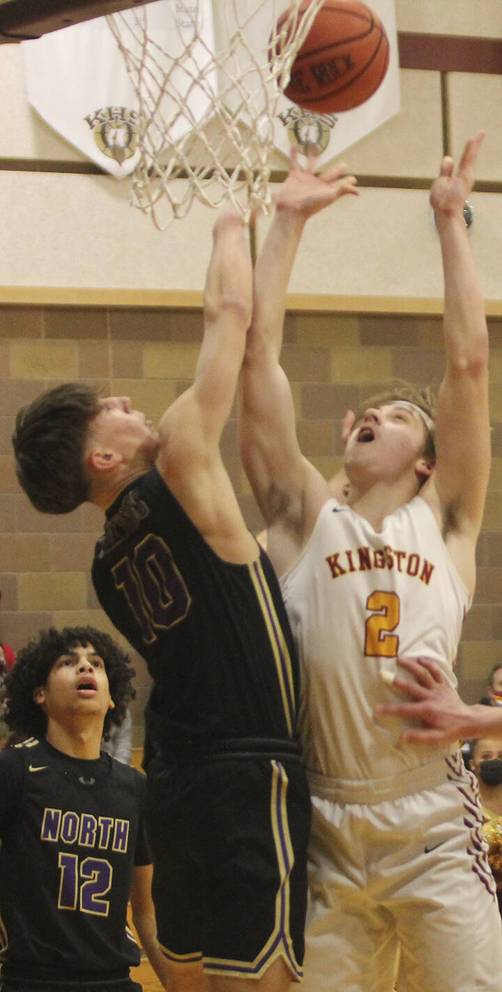 Buc Caden Krantz (2) goes up for a layup against North Kitsap's Cade Orness (10). The Kingston boys have a home playoff game Feb. 16. Steve Powell/File photo