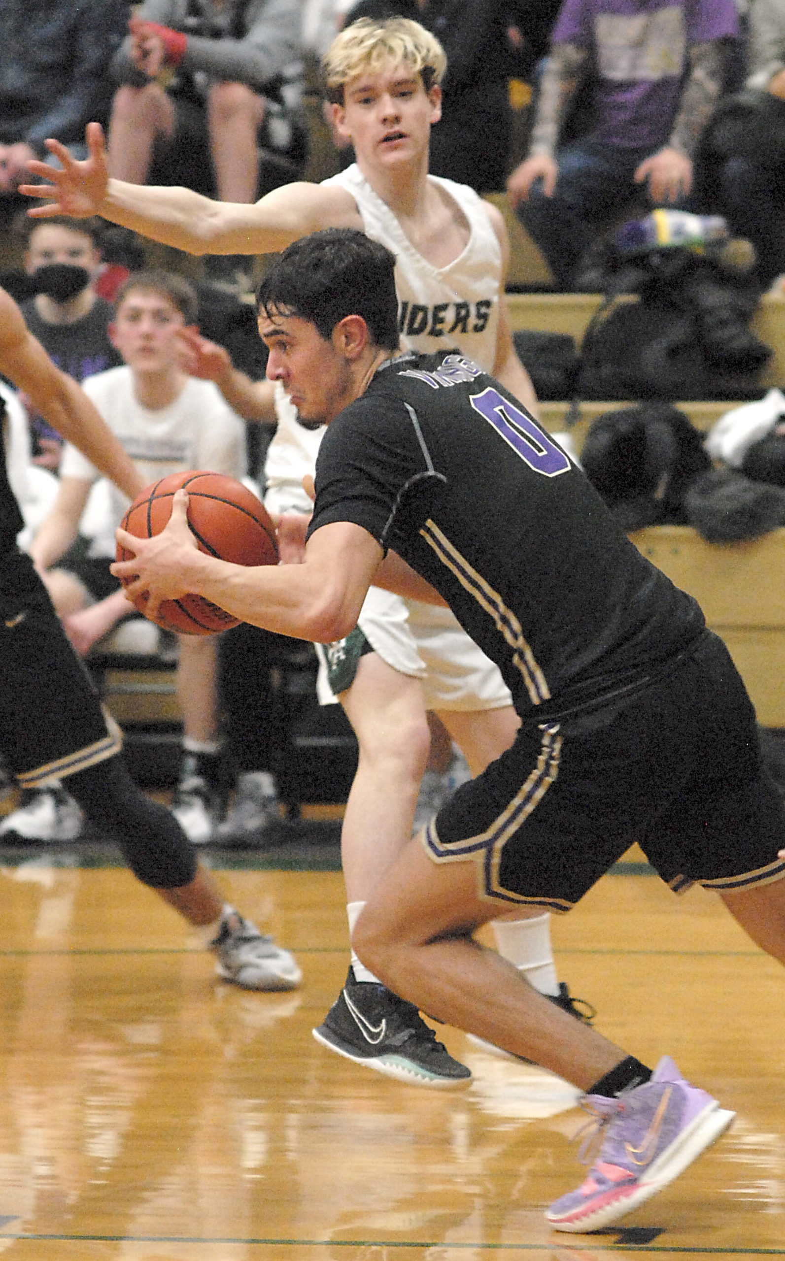 North Kitsap’s Johny Olmsted (0) gets the Viking fastbreak started against Port Angeles Thursday night. PA, however, was able to slow down NK to get the win. Keith Thorpe/For the Herald
