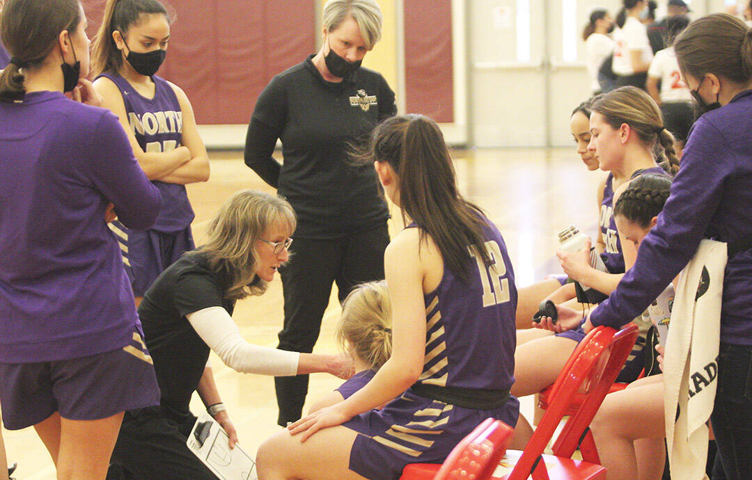 Coach Karla DeVries talks to the team in their playoff win over Renton.
