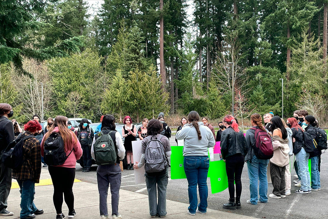 Courtesy Photo
Students hold signs while standing in a circle and talk about racist experiences they’ve had at Kingston High School.