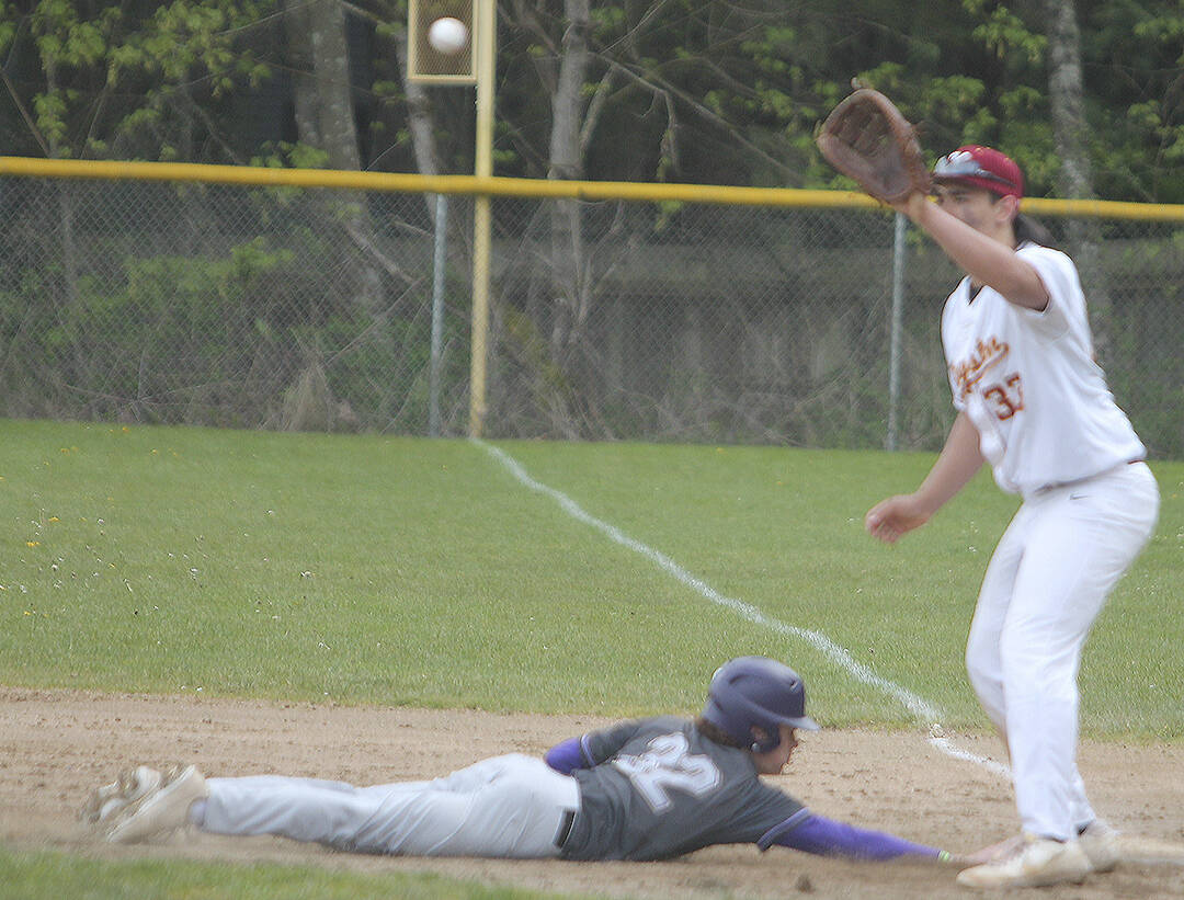 North Kitsap pinch runner sophomore Alex Elton dives safely back to first as Kingston's Peau Tameilau waits on the pickoff throw attempt.