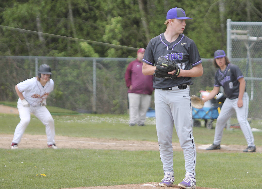 Viking sophomore pitcher Noah Sorenson (11) works from the stretch with a runner at first.