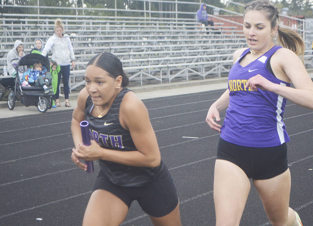 Viking Jasmine Gibson takes off after receiving the handoff from Emerson Bollert during a relay at a recent track meet.
