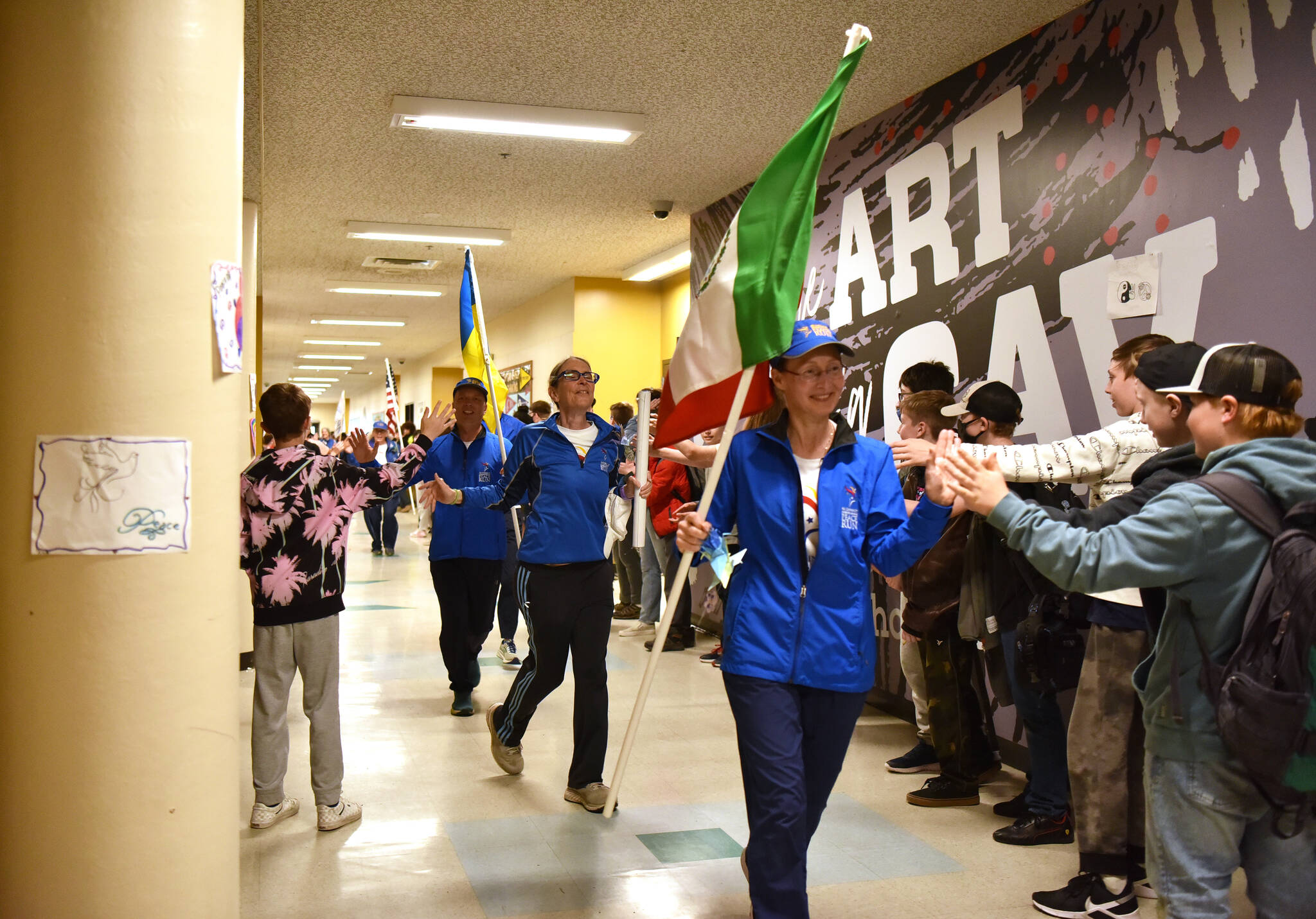 Peace Run team members run through the halls of Kingston Middle School.