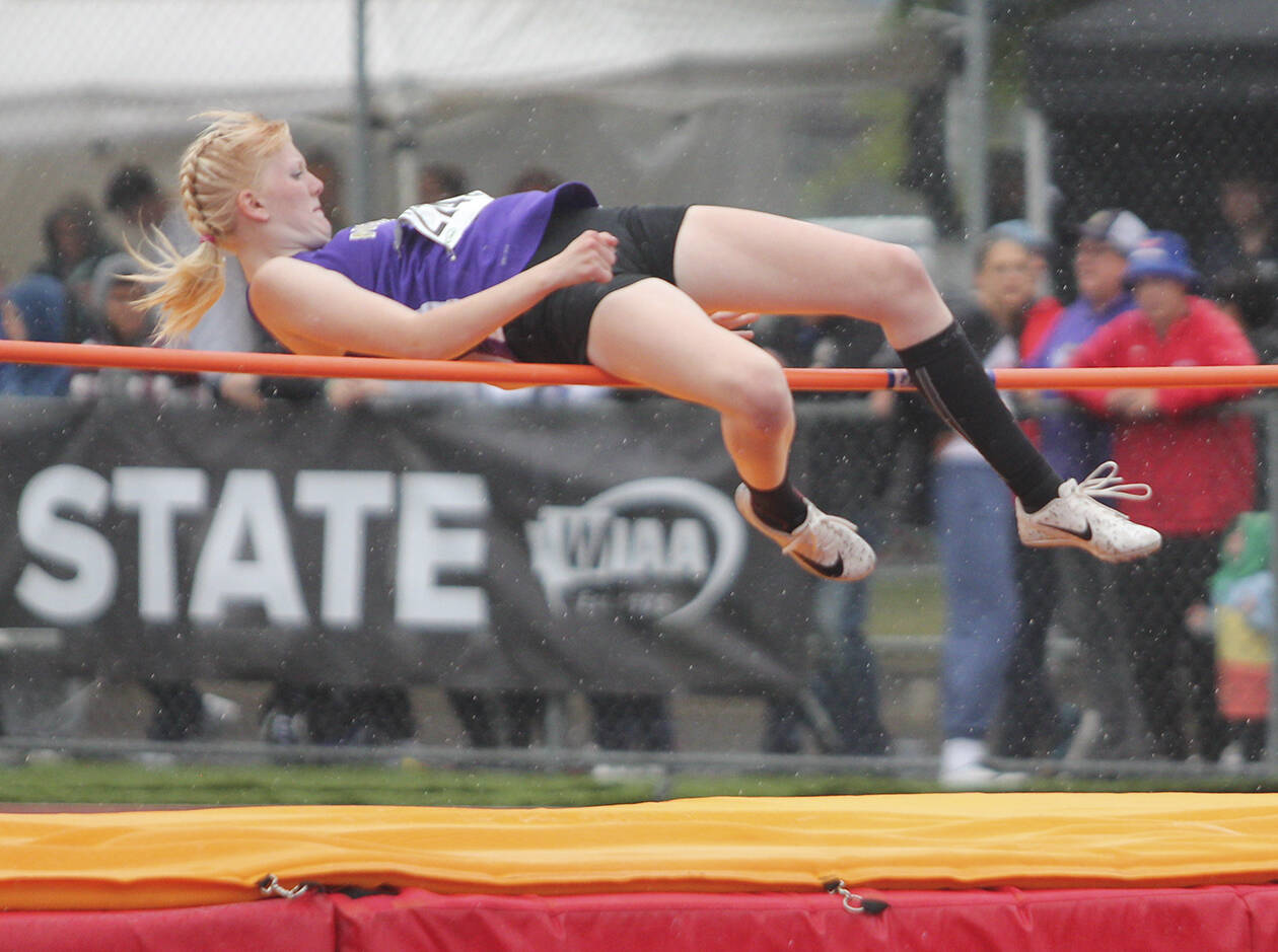 Kate Posten of North Kitsap clears the bar in the high jump at the state meet.