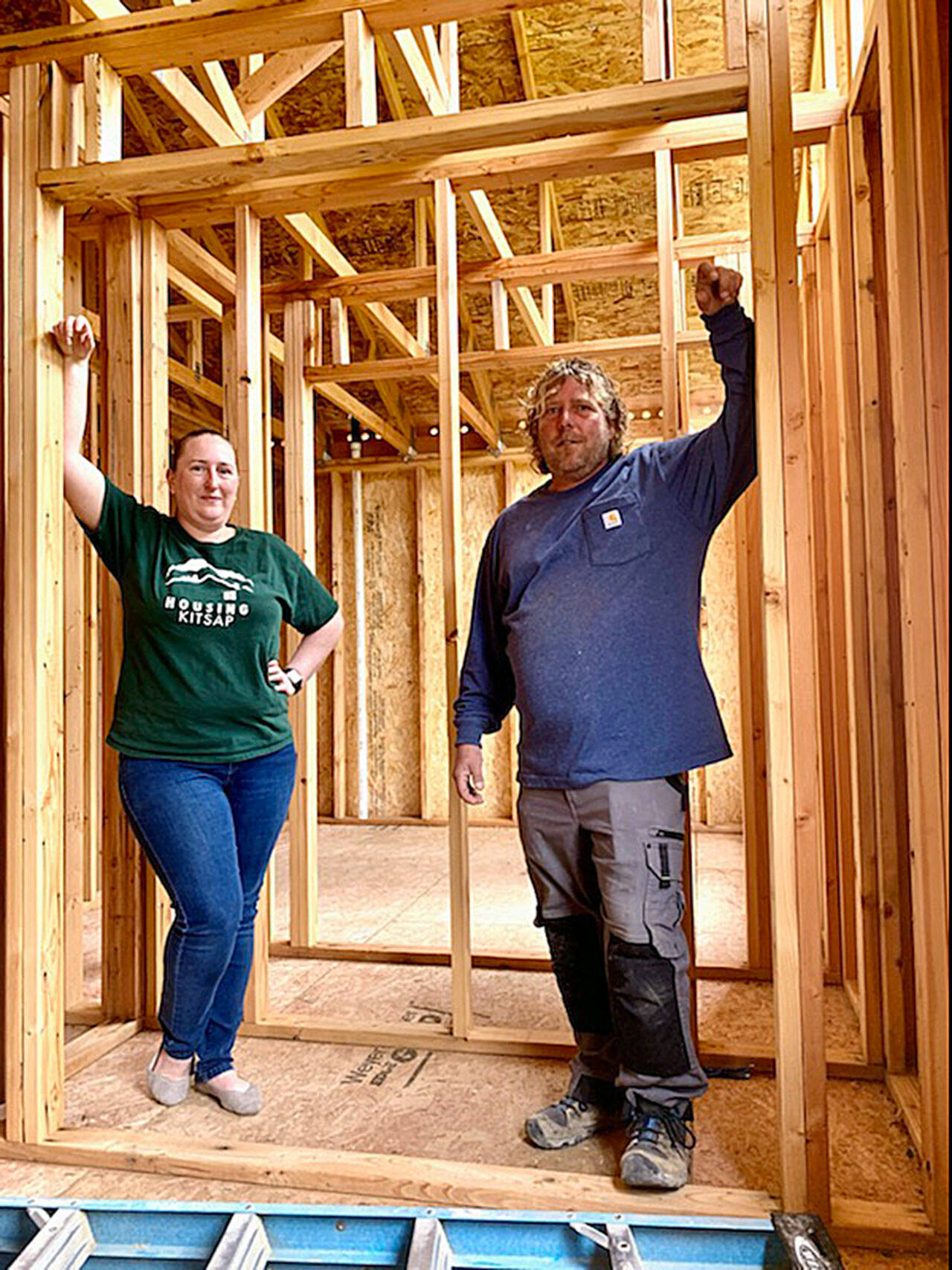 Breanna Littrell, marketing and outreach specialist with Housing Kitsap (left), and site supervisor Chris Evertz assist homeowners through the process of entering the Mutual Self-Help Housing program. (Bob Smith | Kitsap News Group)