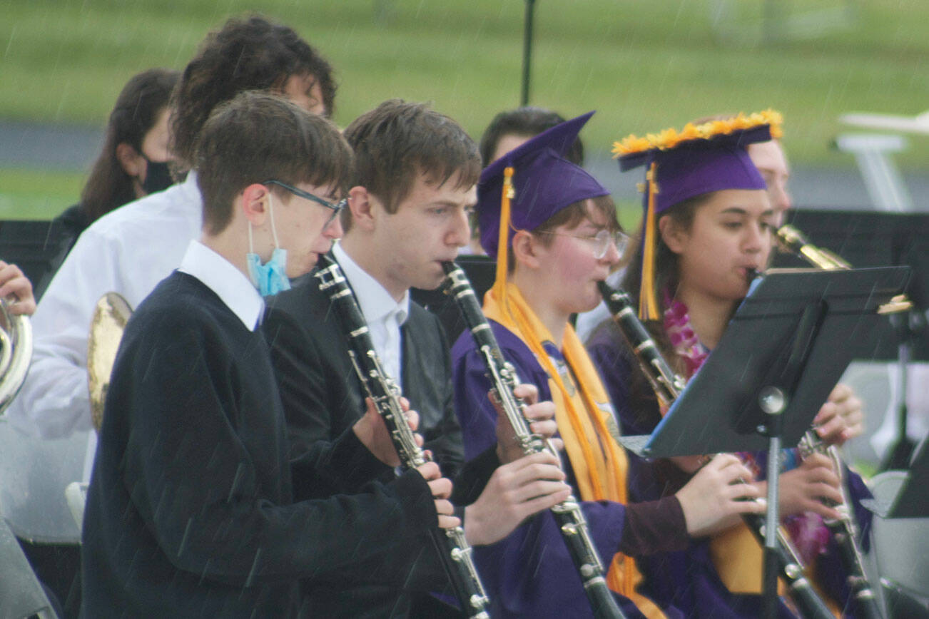 Band members persevered through the rain to perform at graduation.
