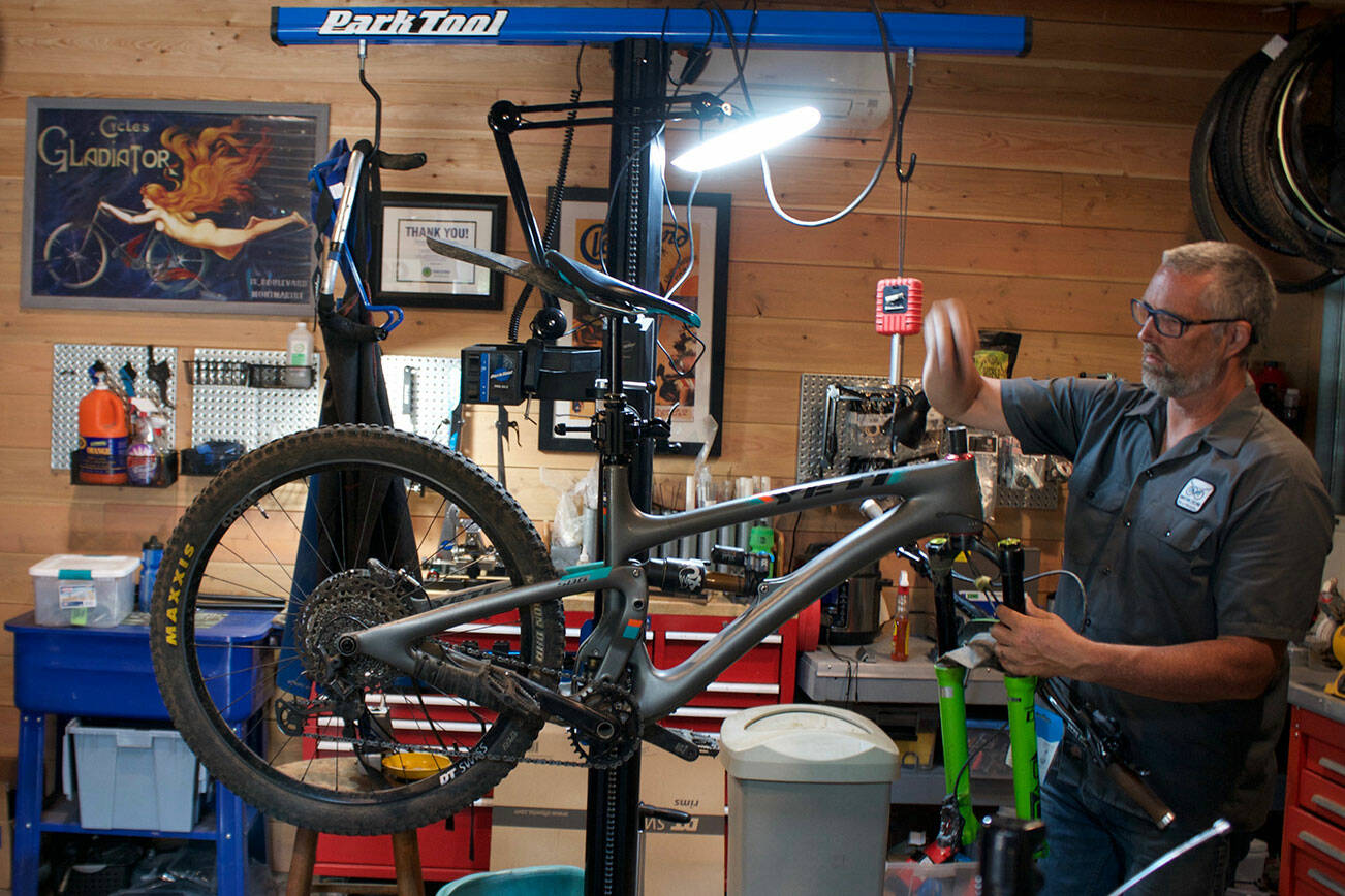 Night Owl Cycling founder Kelly Campo works on a bike in the shop. Tyler Shuey/North Kitsap Herald Photos