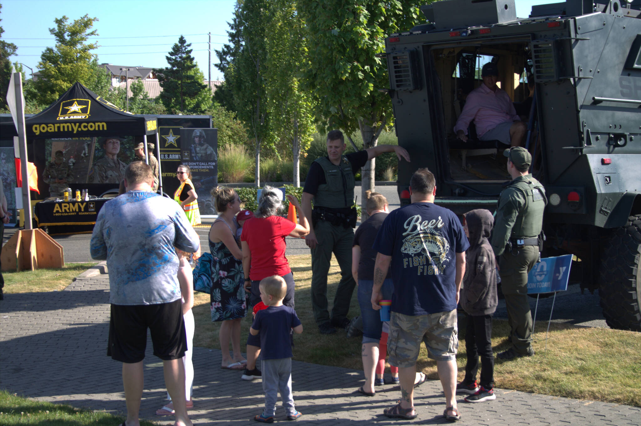 Families gather around a heavy-duty vehicle used by one of Kitsap County’s special units.