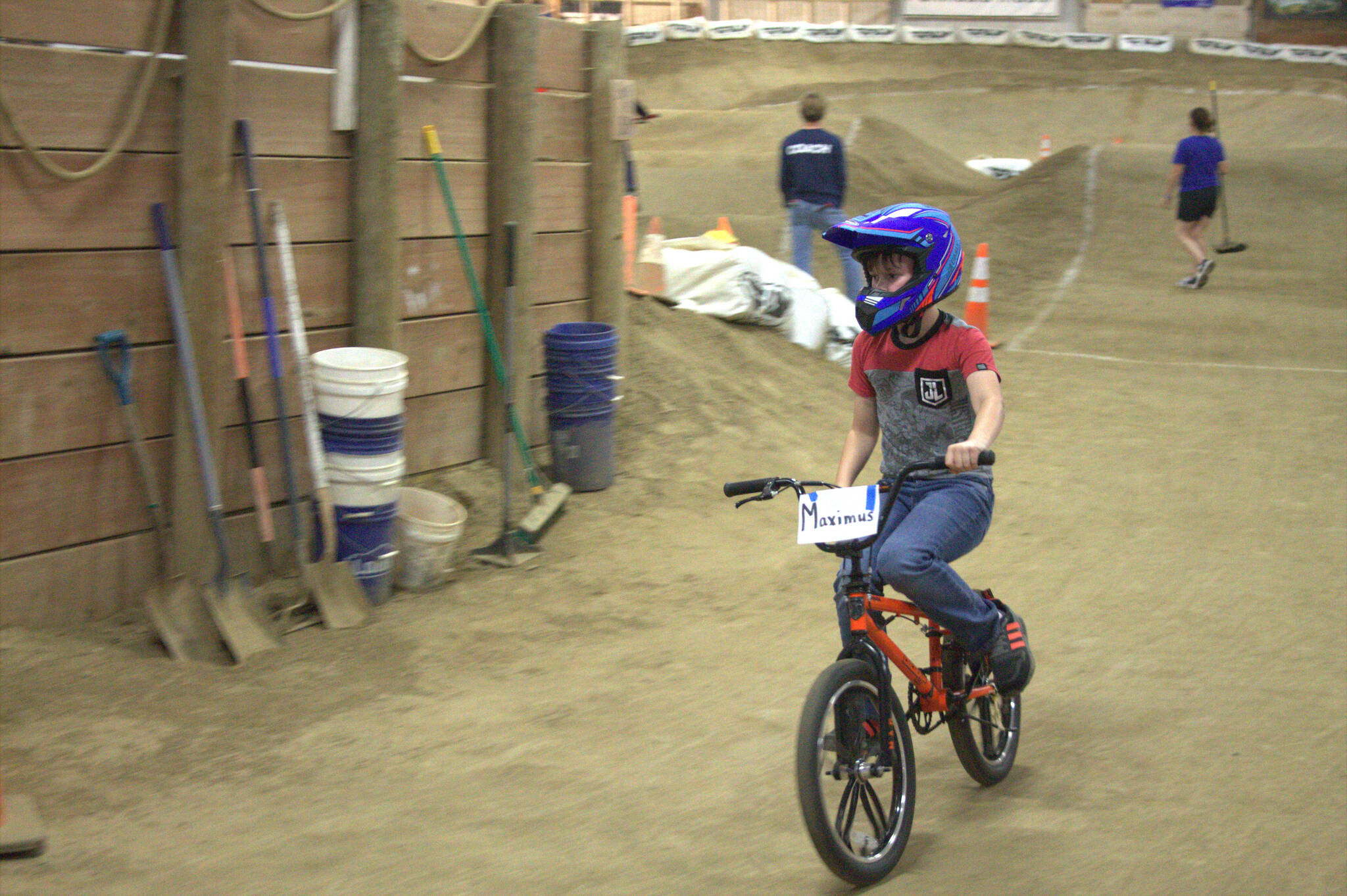 One young rider crosses the finish line after successfully completing a lap.