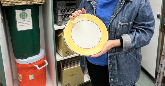 Jane Landry, head librarian for Sustainable Bainbridge Zero Waste Flatware Lending Library, shows off a plate from the collection of items available to community members. Nancy Treder/Kitsap News Group Photos