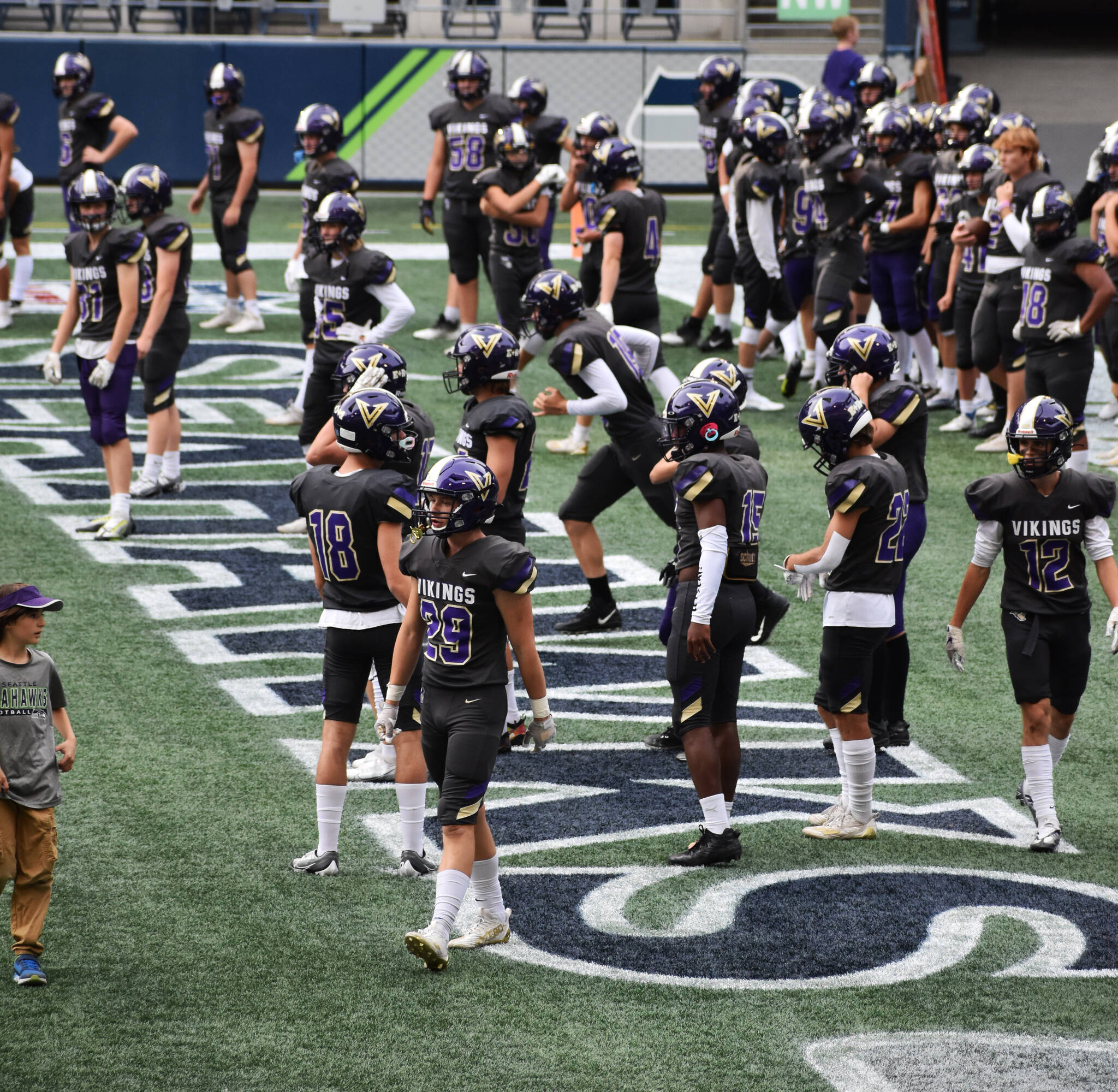 North Kitsap began running drills in the Seahawks’ end zone before playing against Port Angeles at Lumen Field. Nicholas Zeller-Singh/Kitsap News Group